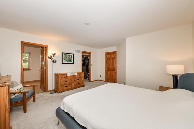 884 Joshua Ct, Pewaukee, WI 53072 - bedroom with light carpet, a spacious closet, a closet, baseboards, and ensuite bath