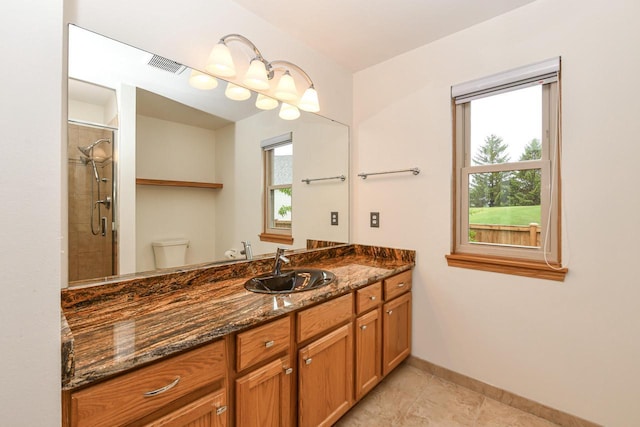 884 Joshua Ct, Pewaukee, WI 53072 - full bathroom featuring toilet, vanity, tile patterned flooring, baseboards, and tiled shower