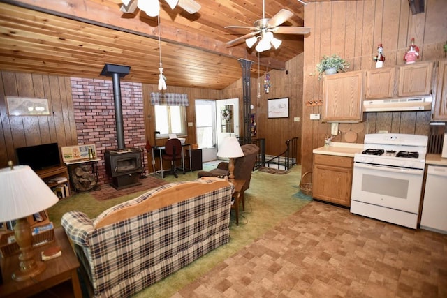 W1829 Broken Bow Rd, Keshena, WI 54135 - living room featuring a wood stove, a ceiling fan, wood walls, wooden ceiling, and vaulted ceiling