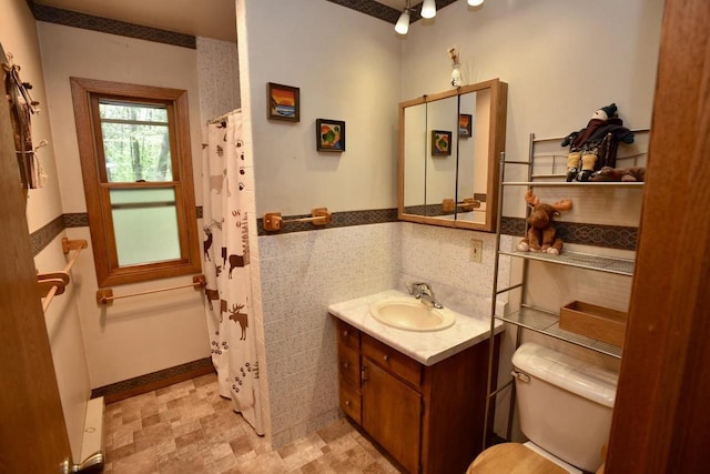W1829 Broken Bow Rd, Keshena, WI 54135 - bathroom featuring toilet, vanity, wainscoting, a shower with shower curtain, and tile walls