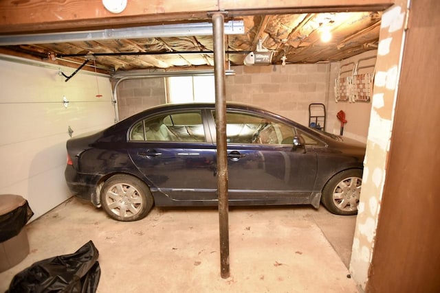 W1829 Broken Bow Rd, Keshena, WI 54135 - garage featuring a garage door opener and concrete block wall
