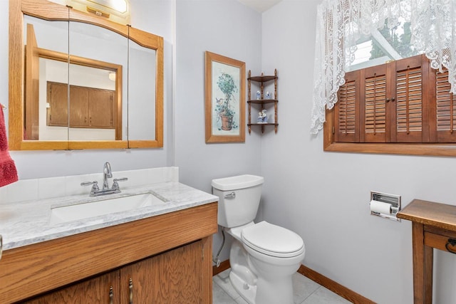 2009 N Eugene St, Appleton, WI 54914 - bathroom with baseboards, toilet, vanity, and tile patterned floors