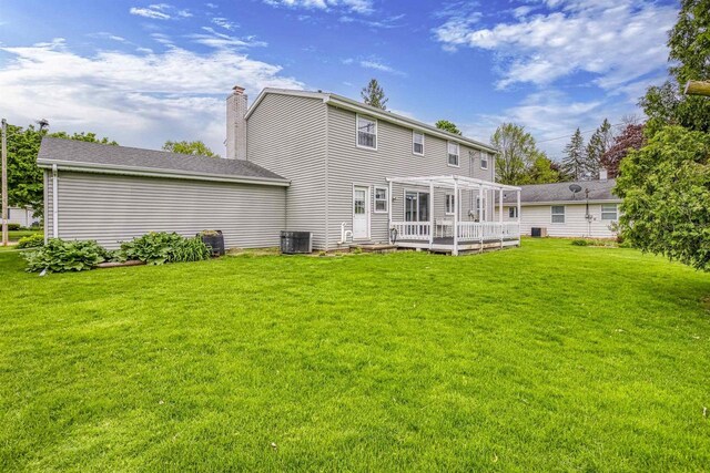 2009 N Eugene St, Appleton, WI 54914 - back of property featuring a wooden deck, a yard, a chimney, and cooling unit