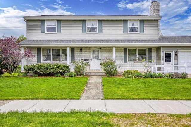 2009 N Eugene St, Appleton, WI 54914 - traditional-style home with a chimney, covered porch, a front yard, and brick siding