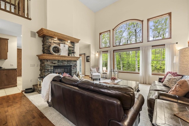 4700 Beaver Dam Rd, Stevens Point, WI 54482 - living room with a high ceiling, a fireplace, and light wood-style floors