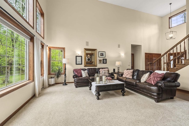 4700 Beaver Dam Rd, Stevens Point, WI 54482 - living area featuring a high ceiling, carpet flooring, baseboards, and stairway
