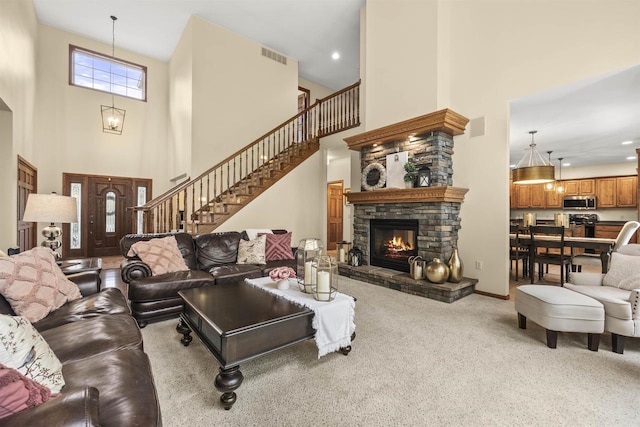 4700 Beaver Dam Rd, Stevens Point, WI 54482 - carpeted living room with a high ceiling, stairs, a fireplace, and baseboards