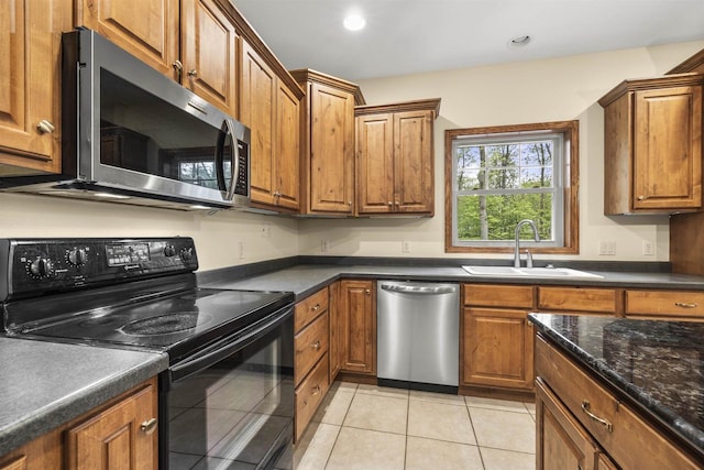 4700 Beaver Dam Rd, Stevens Point, WI 54482 - kitchen featuring stainless steel appliances, a sink, brown cabinets, light tile patterned flooring, and recessed lighting