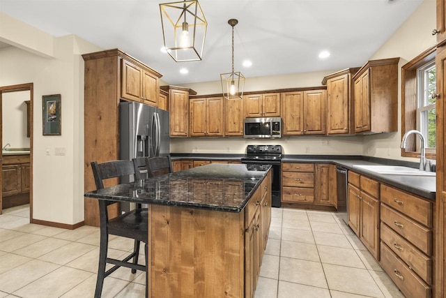 4700 Beaver Dam Rd, Stevens Point, WI 54482 - kitchen featuring stainless steel appliances, a sink, brown cabinets, a center island, and light tile patterned floors