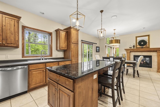 4700 Beaver Dam Rd, Stevens Point, WI 54482 - kitchen with dishwasher, a sink, a center island, light tile patterned floors, and plenty of natural light