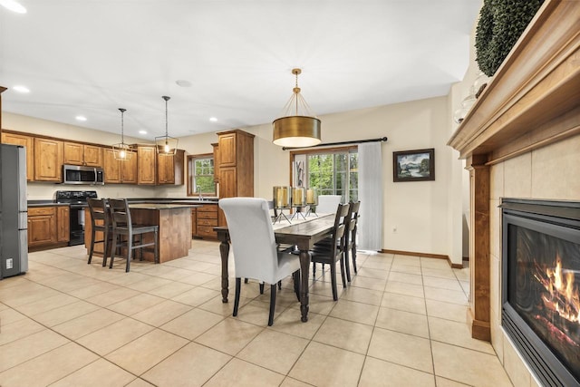 4700 Beaver Dam Rd, Stevens Point, WI 54482 - dining room featuring recessed lighting, light tile patterned flooring, a glass covered fireplace, and baseboards