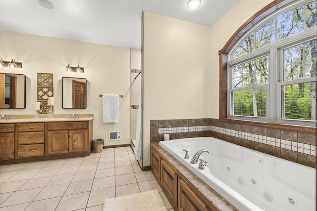 4700 Beaver Dam Rd, Stevens Point, WI 54482 - full bathroom featuring a whirlpool tub, tile patterned flooring, double vanity, a stall shower, and baseboards