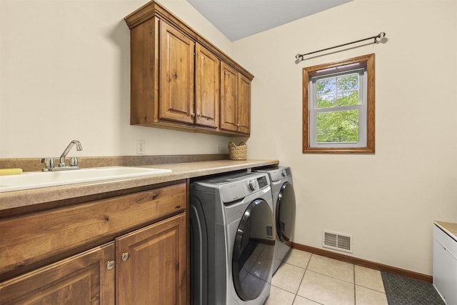 4700 Beaver Dam Rd, Stevens Point, WI 54482 - washroom with washer and clothes dryer, cabinet space, baseboards, and light tile patterned flooring