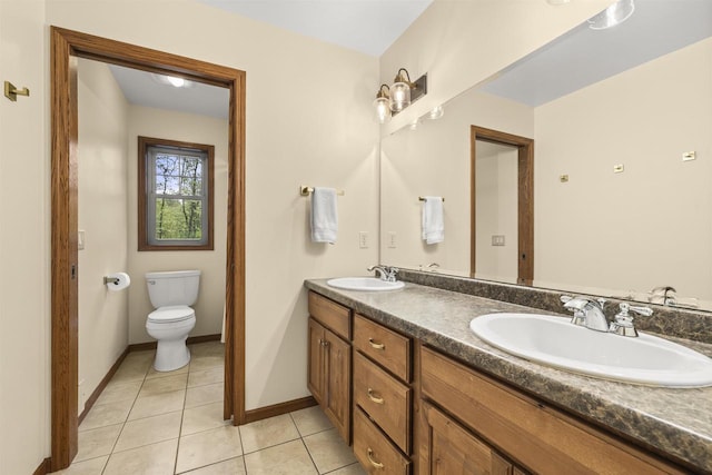 4700 Beaver Dam Rd, Stevens Point, WI 54482 - bathroom with tile patterned floors, double vanity, toilet, and baseboards