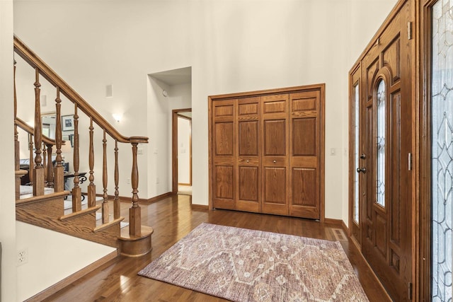 4700 Beaver Dam Rd, Stevens Point, WI 54482 - foyer entrance with baseboards, wood finished floors, stairway, and a towering ceiling