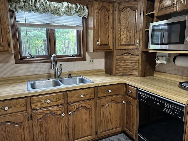 N3615 Badger Ave, Chili, WI 54420 - kitchen featuring dishwasher, stainless steel microwave, a sink, and light countertops