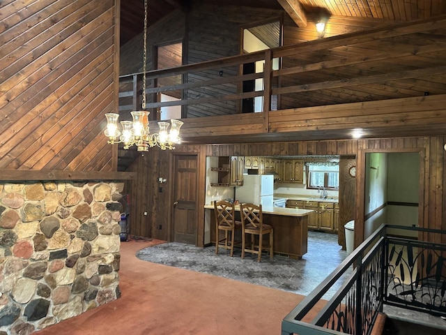 N3615 Badger Ave, Chili, WI 54420 - dining area with wooden walls, high vaulted ceiling, a chandelier, wooden ceiling with exposed beams, and dark carpet