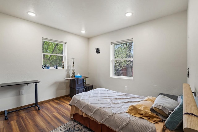 1306 Nelson St, Green Bay, WI 54304 - bedroom with multiple windows, wood finished floors, baseboards, and recessed lighting