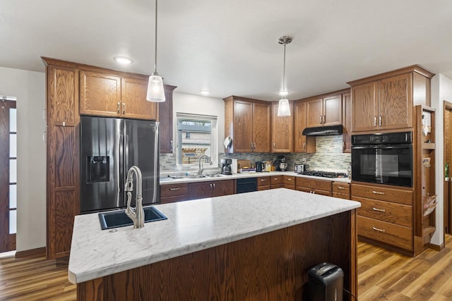1306 Nelson St, Green Bay, WI 54304 - kitchen featuring black appliances, a sink, light wood-style floors, and recessed lighting