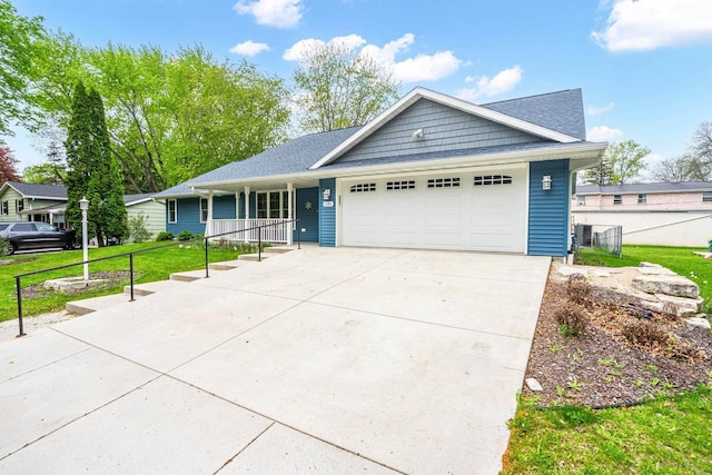 1306 Nelson St, Green Bay, WI 54304 - ranch-style home with an attached garage, a porch, and concrete driveway