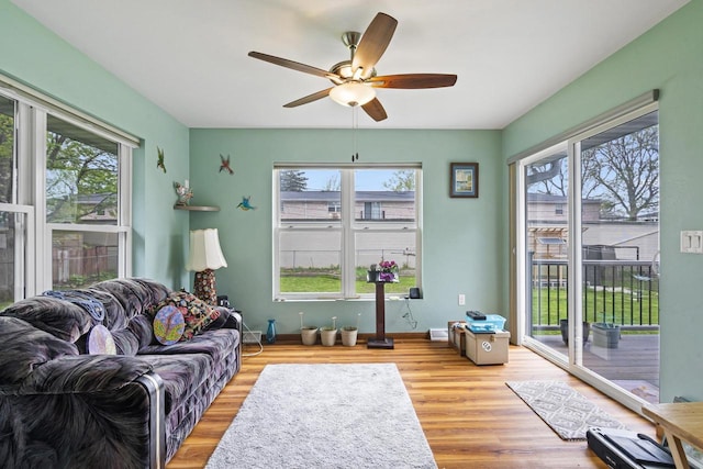 1306 Nelson St, Green Bay, WI 54304 - living area with healthy amount of natural light, ceiling fan, wood finished floors, and baseboards