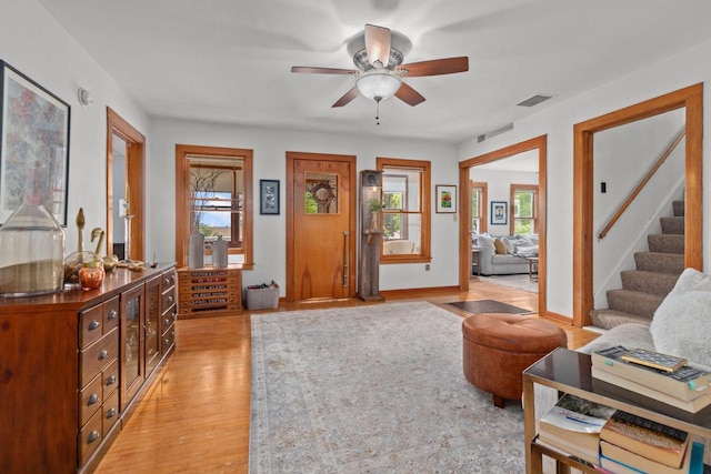 W13491 Reeds Corners Rd, Ripon, WI 54971 - living area featuring plenty of natural light, ceiling fan, stairway, and light wood-style floors