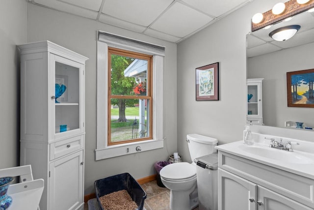 W13491 Reeds Corners Rd, Ripon, WI 54971 - bathroom featuring a paneled ceiling, vanity, toilet, and baseboards