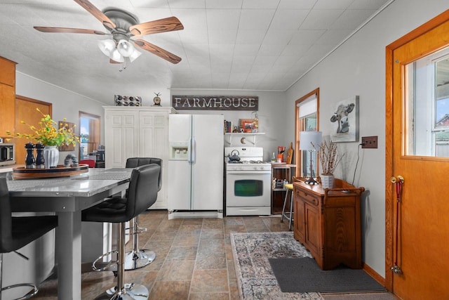 W13491 Reeds Corners Rd, Ripon, WI 54971 - kitchen featuring white appliances, healthy amount of natural light, ceiling fan, and brown cabinetry