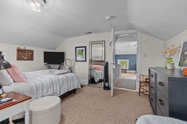 W13491 Reeds Corners Rd, Ripon, WI 54971 - bedroom with vaulted ceiling, light colored carpet, a textured ceiling, and baseboards