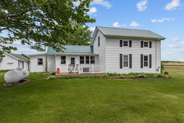 W13491 Reeds Corners Rd, Ripon, WI 54971 - rear view of house with a yard, a wooden deck, metal roof, and a standing seam roof