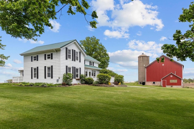 W13491 Reeds Corners Rd, Ripon, WI 54971 - view of front of house featuring a front lawn, an outdoor structure, a barn, and metal roof