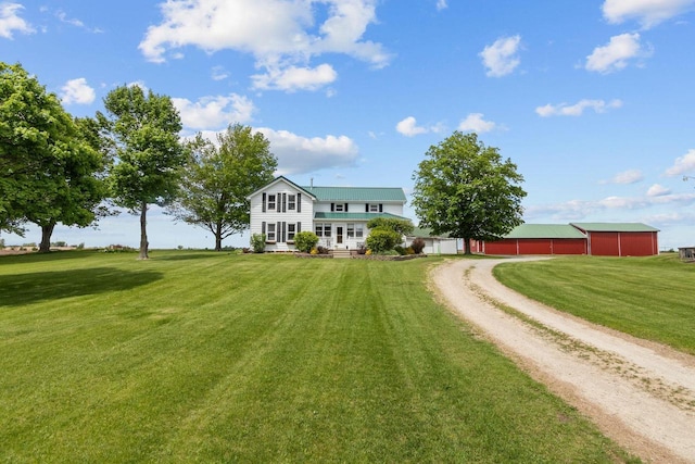 W13491 Reeds Corners Rd, Ripon, WI 54971 - view of front of property with dirt driveway, a front lawn, a pole building, an outbuilding, and a garage