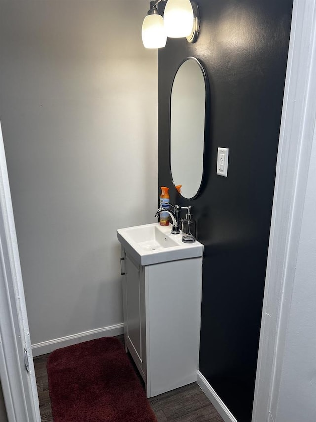 24 W Cottonwood Ln, Milton, WI 53563 - bathroom with baseboards, vanity, and wood finished floors