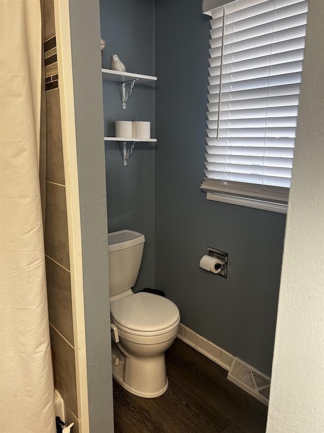 24 W Cottonwood Ln, Milton, WI 53563 - bathroom with wood finished floors, toilet, and baseboards