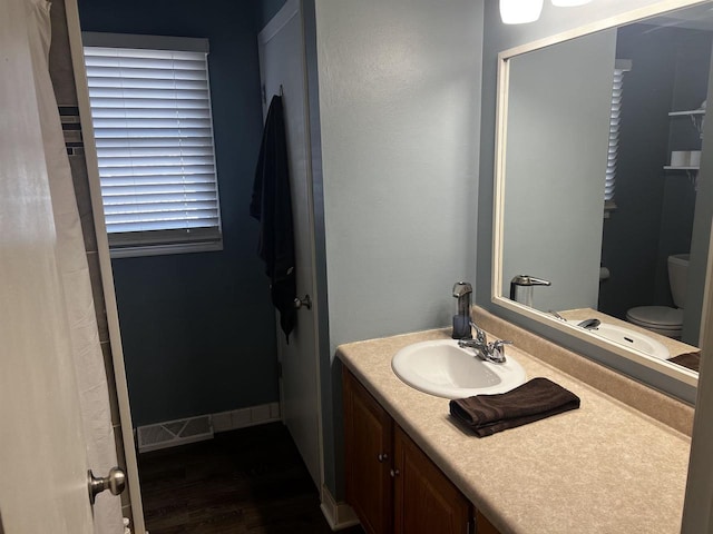 24 W Cottonwood Ln, Milton, WI 53563 - bathroom featuring wood finished floors, toilet, and vanity