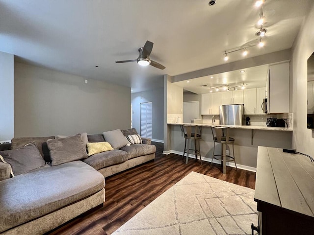234 N Broadway Unit 302, Milwaukee, WI 53202 - living area with rail lighting, dark wood-style floors, ceiling fan, and baseboards