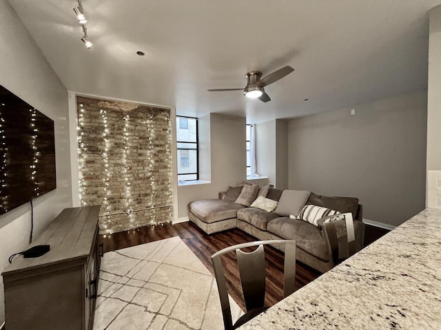 234 N Broadway Unit 302, Milwaukee, WI 53202 - living area with wood finished floors, ceiling fan, baseboards, and track lighting