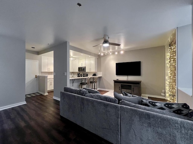 234 N Broadway Unit 302, Milwaukee, WI 53202 - living area with dark wood-style flooring, ceiling fan, track lighting, and baseboards