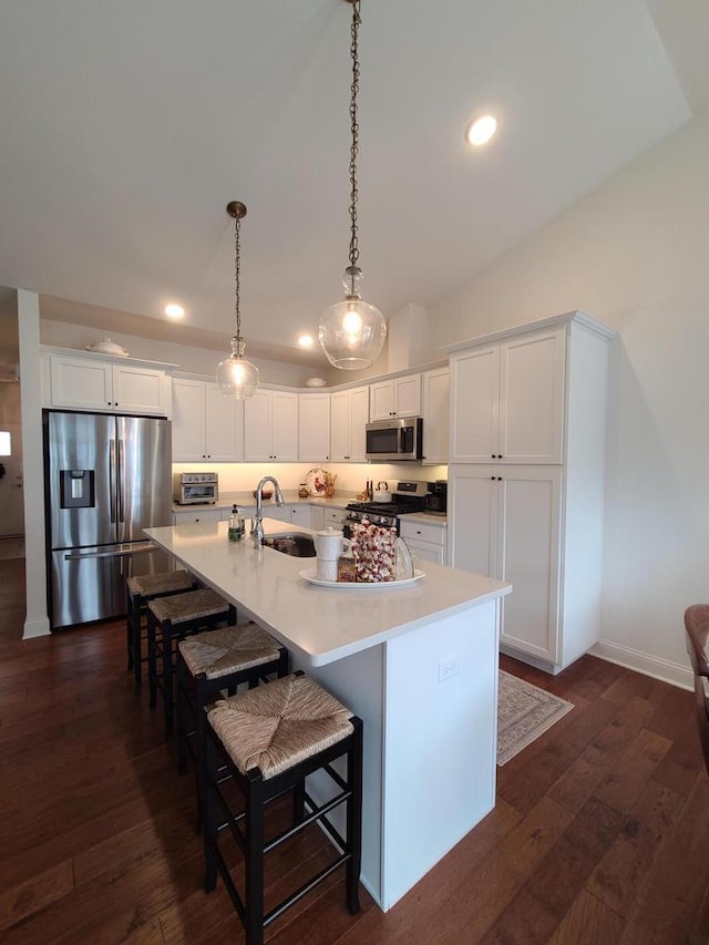 609 Cadence Cir, Lake Geneva, WI 53147 - kitchen with stainless steel appliances, a sink, white cabinetry, a spacious island, and recessed lighting