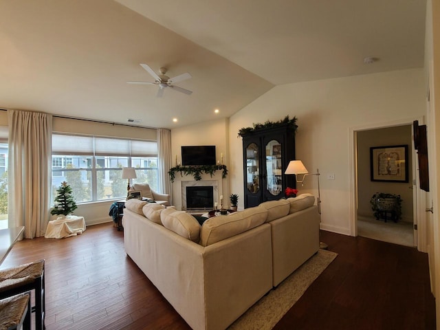 609 Cadence Cir, Lake Geneva, WI 53147 - living area featuring lofted ceiling, dark wood-type flooring, a glass covered fireplace, a ceiling fan, and baseboards