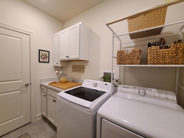 609 Cadence Cir, Lake Geneva, WI 53147 - laundry room featuring washer and clothes dryer, cabinet space, and light tile patterned floors