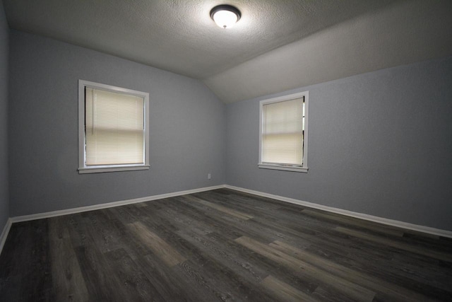 4618 N 36th St, Milwaukee, WI 53209 - additional living space featuring vaulted ceiling, dark wood-type flooring, a textured ceiling, and baseboards