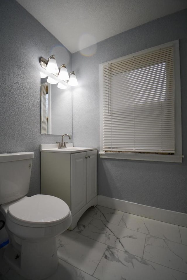 4618 N 36th St, Milwaukee, WI 53209 - bathroom with a textured wall, baseboards, vanity, toilet, and marble look tile flooring