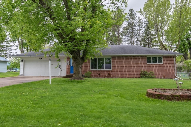205 W Hickory St, Abbotsford, WI 54405 - view of front facade with driveway, an attached garage, a front yard, and brick siding