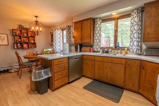 205 W Hickory St, Abbotsford, WI 54405 - kitchen with dishwasher, a sink, light wood-style floors, and brown cabinetry