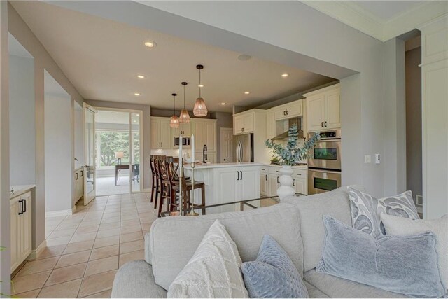 278 Saint Annes Pkwy, Hudson, WI 54016 - living area featuring light tile patterned floors, recessed lighting, baseboards, and crown molding