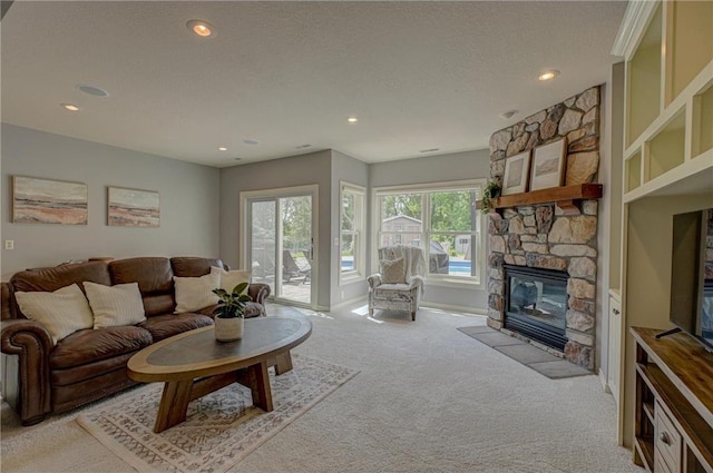 278 Saint Annes Pkwy, Hudson, WI 54016 - living room featuring light carpet, a stone fireplace, recessed lighting, and baseboards