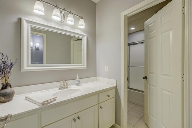278 Saint Annes Pkwy, Hudson, WI 54016 - full bathroom featuring vanity, tile patterned floors, and bath / shower combo with glass door