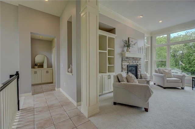 278 Saint Annes Pkwy, Hudson, WI 54016 - living area featuring light carpet, ornamental molding, a stone fireplace, light tile patterned floors, and baseboards