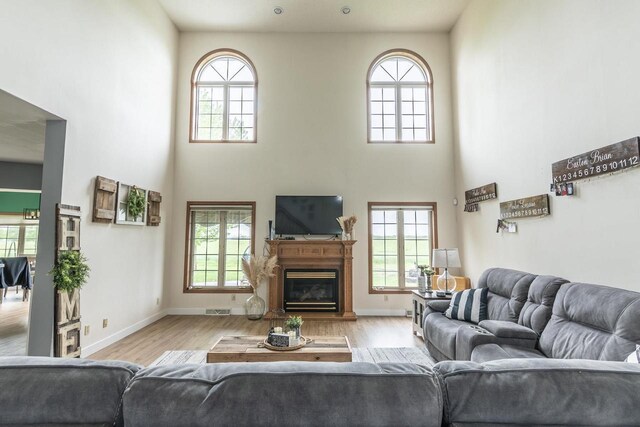 315 N 7th St, Colby, WI 54421 - living room with a towering ceiling, plenty of natural light, wood finished floors, and a glass covered fireplace